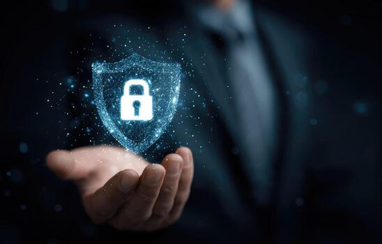 Businessman holding a padlock and shield with a digital lock on it photo