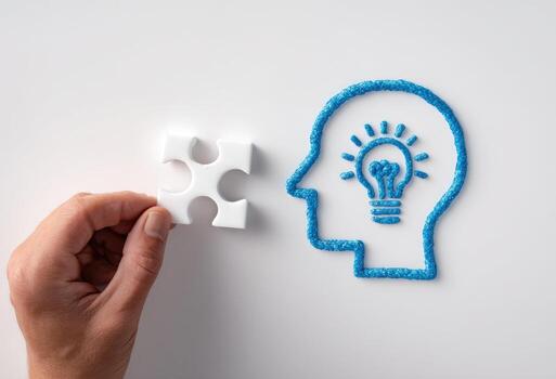 Hand holding a piece of jigsaw puzzle with a light bulb in the middle photo