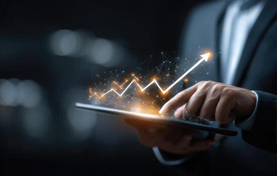 Businessman using tablet with graph and business chart photo