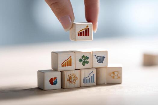 A person placing wooden cubes with different icons on them photo