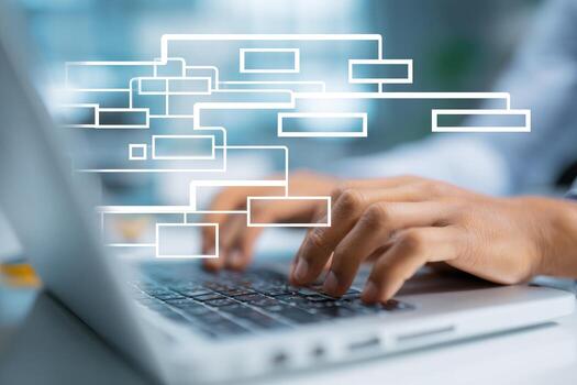 Man typing on laptop with diagram on screen photo