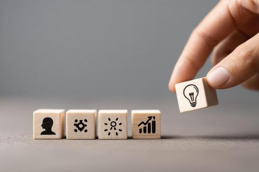 Hand placing wooden cubes with icons on them photo