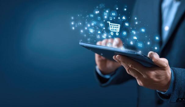 Man in business suit holding tablet with shopping icons photo