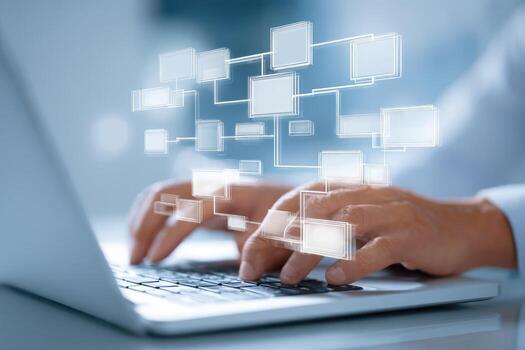 A person typing on a laptop computer with a network diagram photo