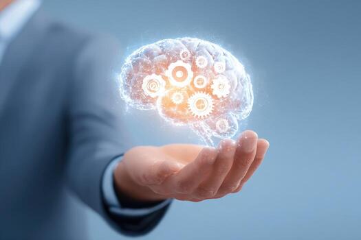 Businessman holding a glowing brain with gears photo