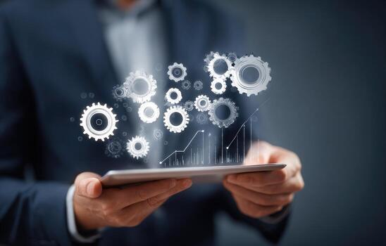 Businessman holding tablet with gears and graphs photo