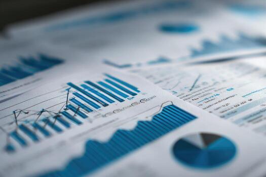 A pile of papers with graphs and charts on them photo
