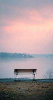 un banco sentado en un playa por un lago foto