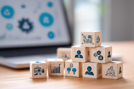 Wooden cubes with icons on them sitting on a desk photo