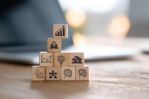 Wooden blocks with icons on them sitting on a desk photo