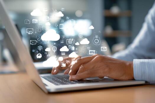 Man typing on laptop with cloud icons photo