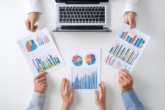 Business people holding papers with graphs and graphs photo