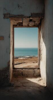 A window in an old building with the ocean view photo