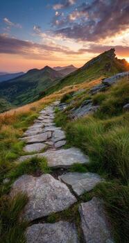 A stone path leads up to a mountain at sunset photo