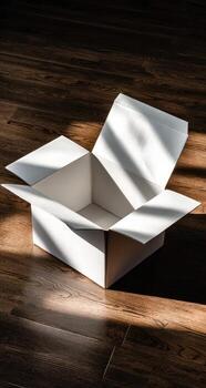An open white box sitting on a wooden floor photo