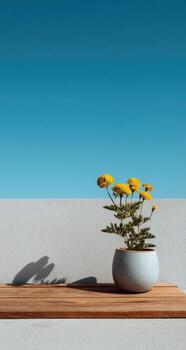 A vase with yellow flowers sitting on a table photo