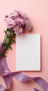 Blank card with flowers and ribbon on pink background photo