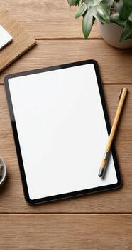 Tablet with blank screen and pen on wooden table photo