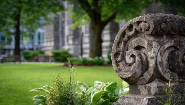 A stone column in the middle of a grassy field photo