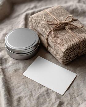 A jar of soap, a card and a cloth on a bed photo