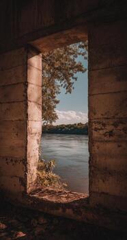 A window in an old building with a view of the river photo