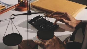 A man is using a calculator to calculate the amount of money he owes video