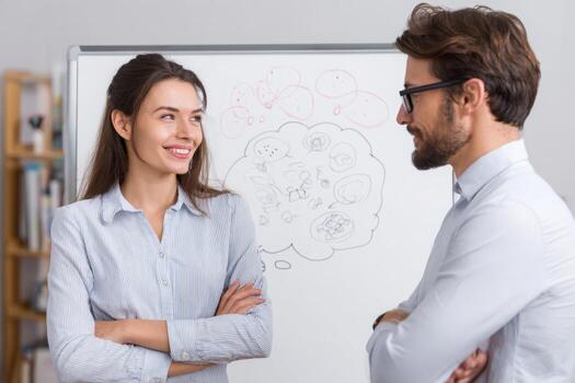 A therapist listens attentively as a patient discusses thoughts and feelings. Diagrams illustrating cognitive processes are drawn on a whiteboard in a cozy office photo