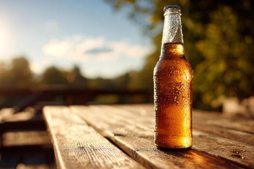 A cold bottle filled with a fizzy drink stands on a rustic wooden table. The sunlight shines brightly, creating a warm glow that enhances the tranquil outdoor atmosphere photo