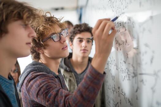 Three high school students engage in a math study session, focusing on equations written on the whiteboard. They display teamwork and concentration while learning together photo