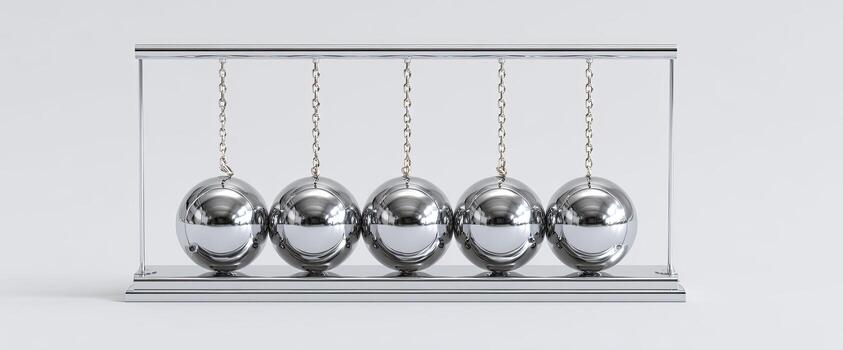 A Newton's cradle, silver spheres hanging from chains within a clear frame, on white background photo