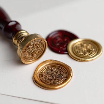 Close-up shows a sealing stamp with wax seals of varied colors and designs photo