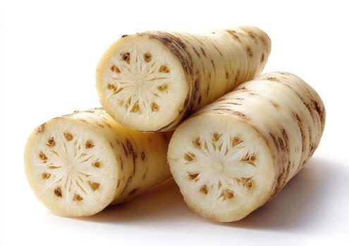 Close-up of three sliced white root vegetables showing interior floral pattern photo