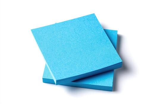 Two stacks of square, cyan notepads, casting a shadow on a plain white background photo