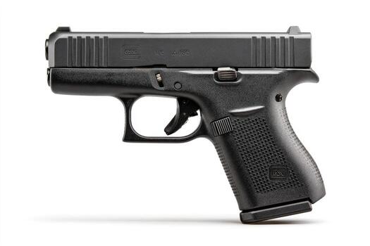 A semi-automatic handgun, dark gray, angled on a white background, showing details photo