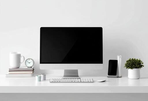 Minimalist desk setup with a computer, clock, cup, books, phone, and plant against a white backdrop photo