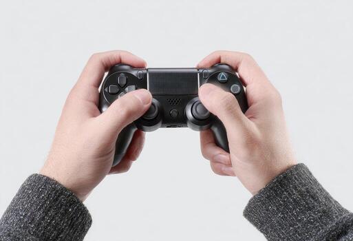 Close-up of hands holding a black game controller against a white background photo