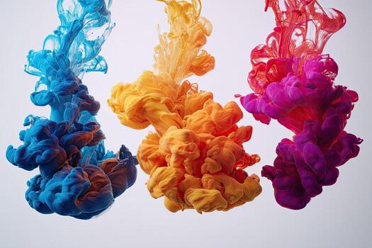 Three columns of colorful ink plumes suspend in liquid against a neutral backdrop photo
