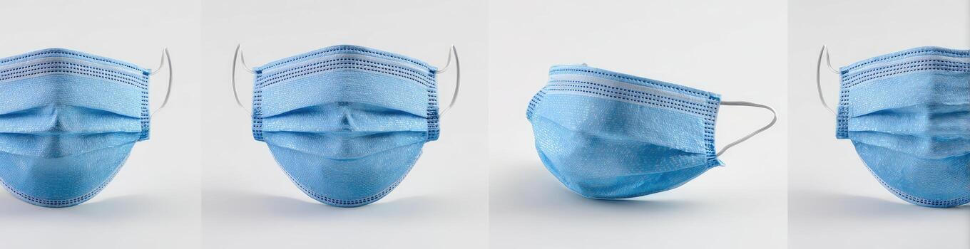 Four disposable face masks of the same type are shown in different angled positions photo