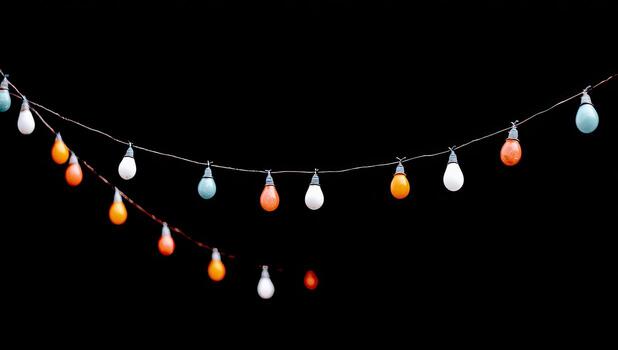 String of colorful light bulbs on a dark background photo