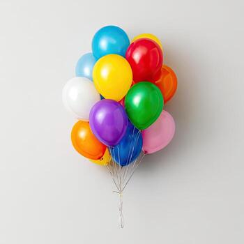 Colorful balloons, clustered together, against a plain white background, casting gentle shadows photo