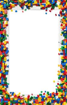 Colorful plastic building blocks frame a blank white space photo