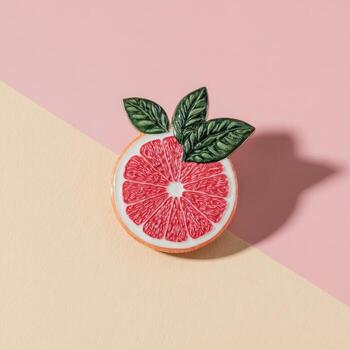 A stylized grapefruit slice with green leaves on a diagonal split background photo