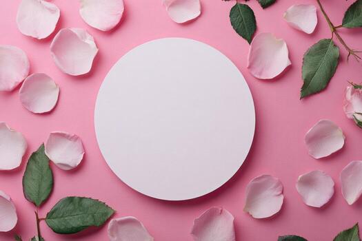 Top-down shot pink surface with scattered petals, green leaves, and a blank white circle photo