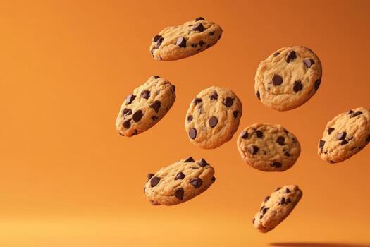 Cookies Levitation. Creative food template. Chocolate chip cookie bursting flying in midair on orange color background. Magazine, banner, advertisement. Copy text space. Falling broken biscuits photo