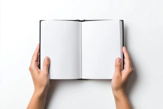 Person holding an opened book with blank pages. Two hands holding a blank magazine or catalog with an open blank white page on a gray background. Template for design, mockup, copy space. Top view photo