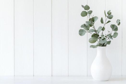 Eucalyptus branch in a Stylish Ceramic Vase on a Table. Detail of Contemporary Cozy Interior. Blank Space for Text on Wooden Wall. Nordic Background. Minimalistic Scandinavian Style. Empty Mockup. photo