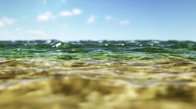 Serene Ocean Waves Gently Lapping on Sandy Beach Under Bright Blue Sky with Fluffy Clouds photo