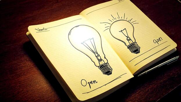 Inspiring idea bulb sketches in an open notebook with a pen, sparking creativity and innovation for brilliant concepts photo