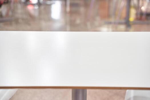 Empty modern table in bright indoor setting with blurred background. photo