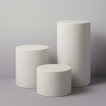 Three minimalist cylindrical pedestals for product display on a neutral photo